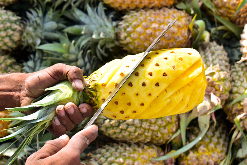 Slicing pineapple